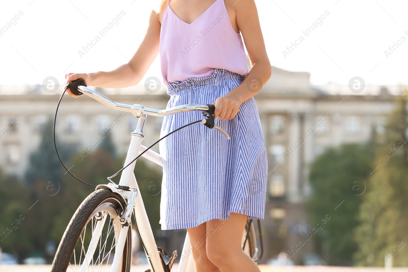 Photo of Beautiful woman with bicycle on street, closeup