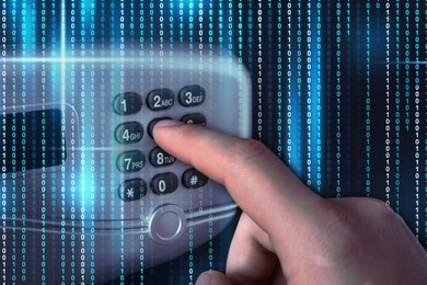 Image of Man pressing buttons on keypad to open steel safe, closeup. Binary code symbolizing digital lock system