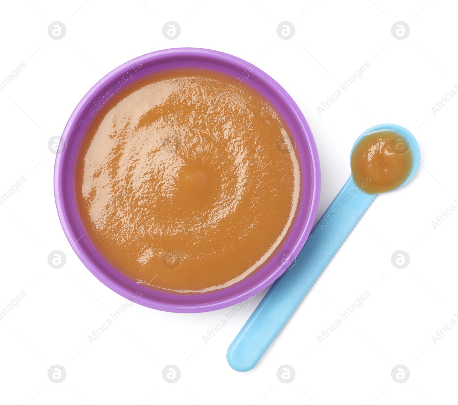 Photo of Delicious baby food in bowl and spoon isolated on white, top view