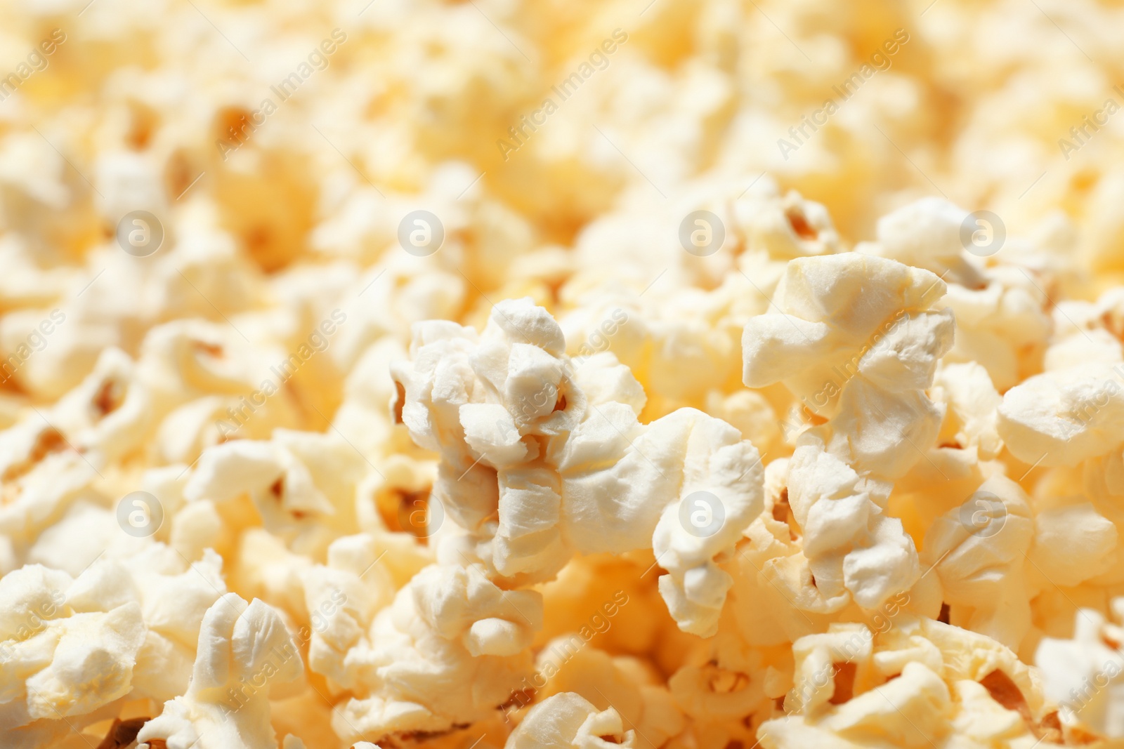 Photo of Fresh popcorn as background, closeup. Tasty snack