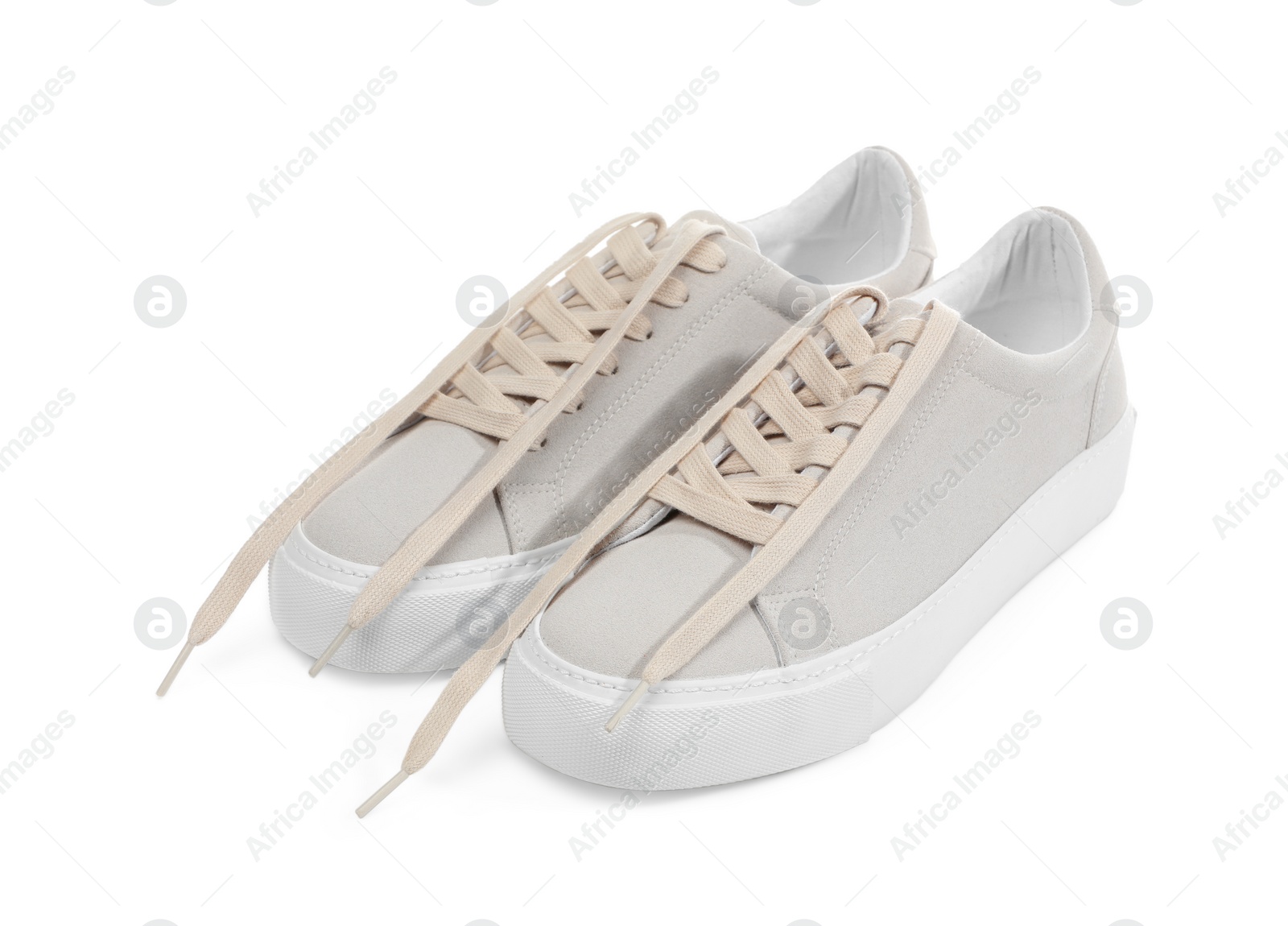 Photo of Pair of stylish beige sneakers isolated on white