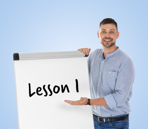 Image of English teacher near flip chart board on light blue background