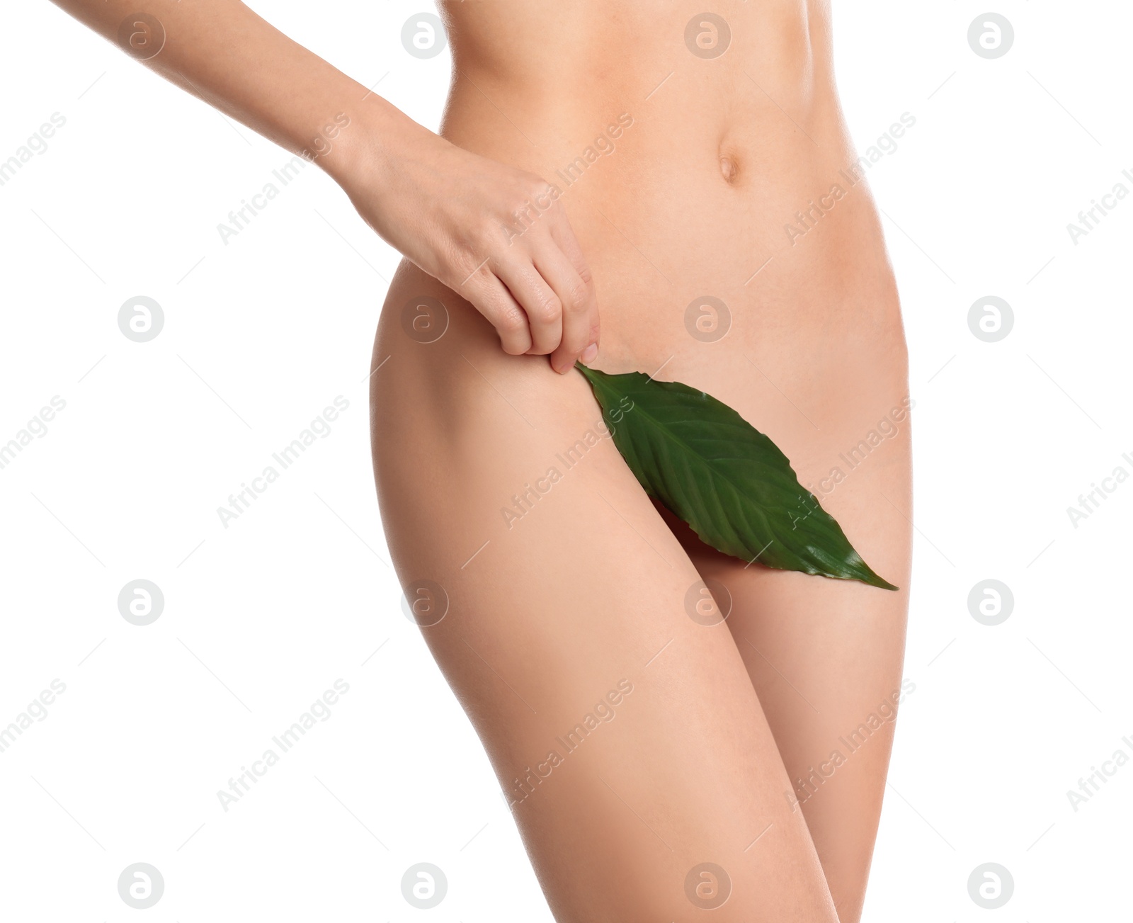 Photo of Woman with leaf showing smooth skin after Brazilian bikini epilation on white background, closeup. Body care concept