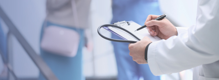 Doctor checking patient's analysis results in hospital, closeup. Banner design