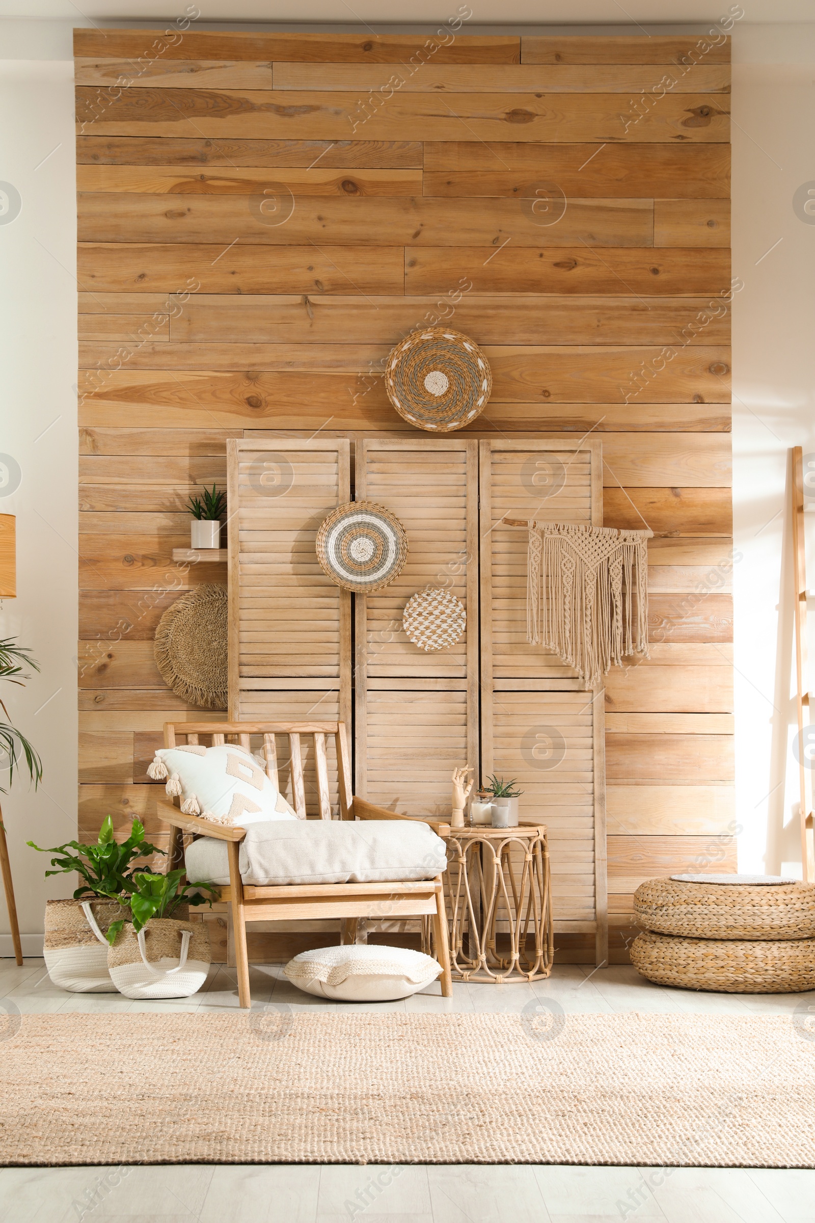 Photo of Stylish living room interior with comfortable wooden armchair and beautiful houseplants