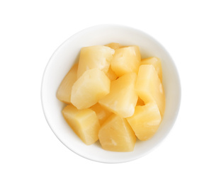 Photo of Pieces of delicious canned pineapple in bowl on white background, top view