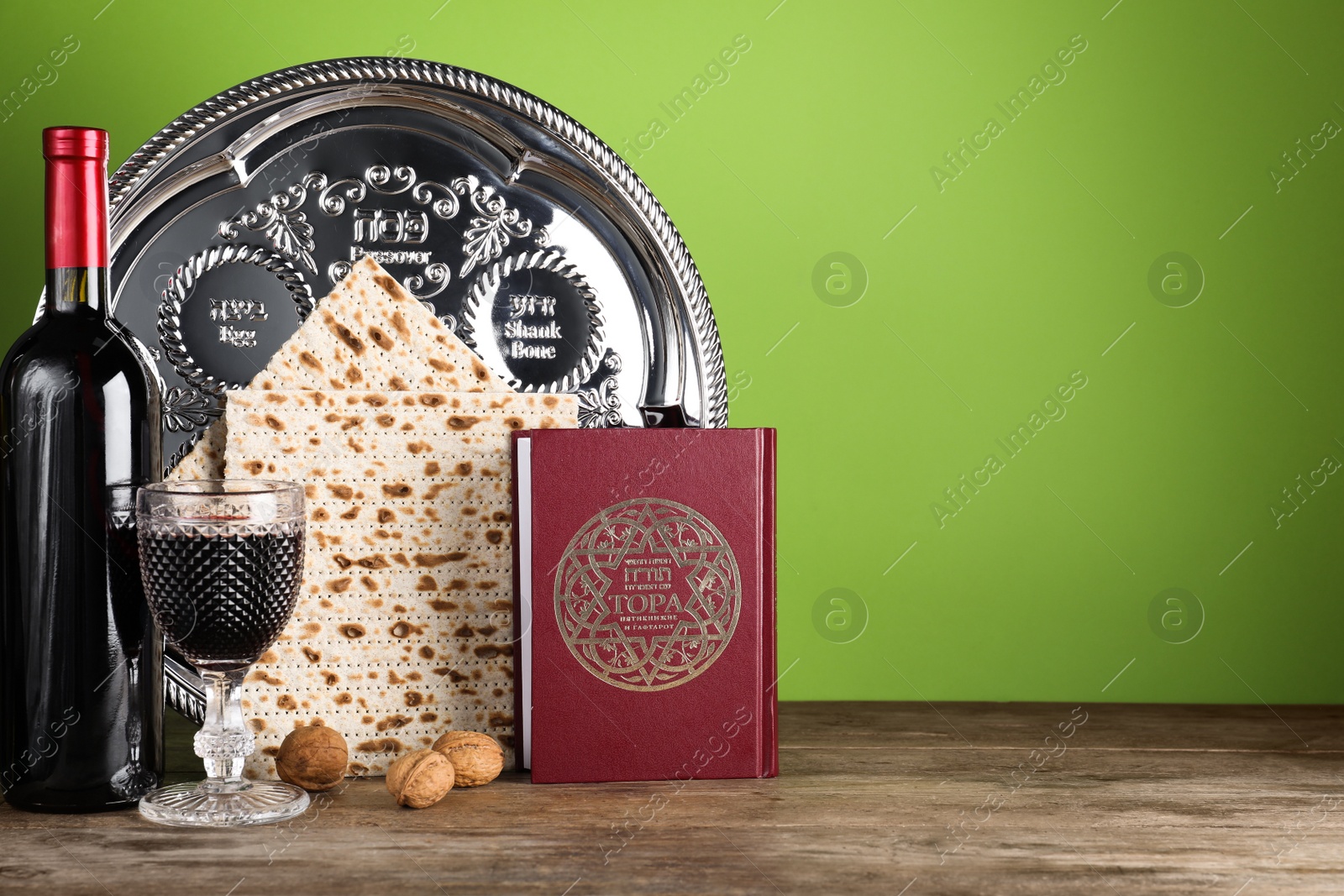 Photo of Symbolic Pesach (Passover Seder) items on wooden table, space for text