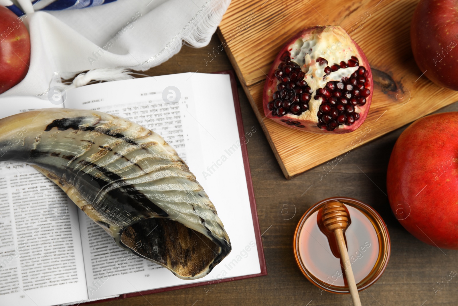 Photo of Flat lay composition with Rosh Hashanah holiday symbols on wooden table