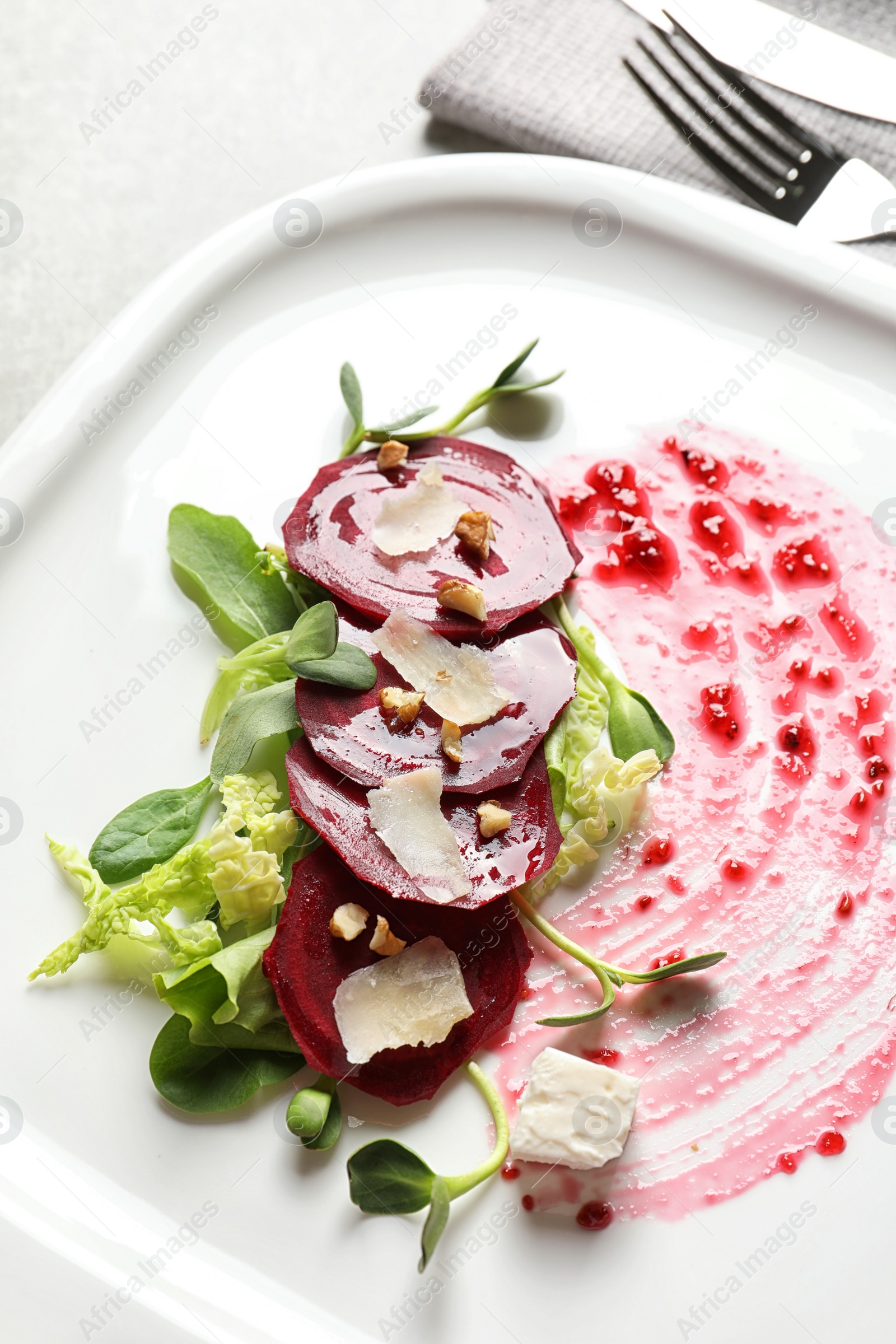 Photo of Plate with delicious beet salad served on table