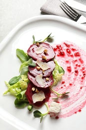 Plate with delicious beet salad served on table