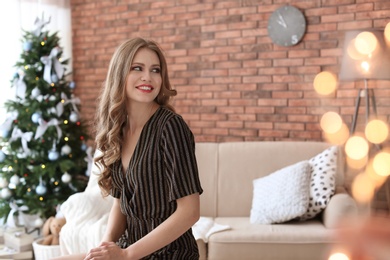 Beautiful young woman at home. Celebrating Christmas