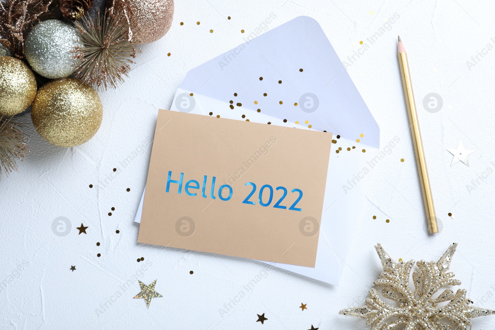 Image of Card with text Hello 2022, envelope and Christmas decor on white background, flat lay