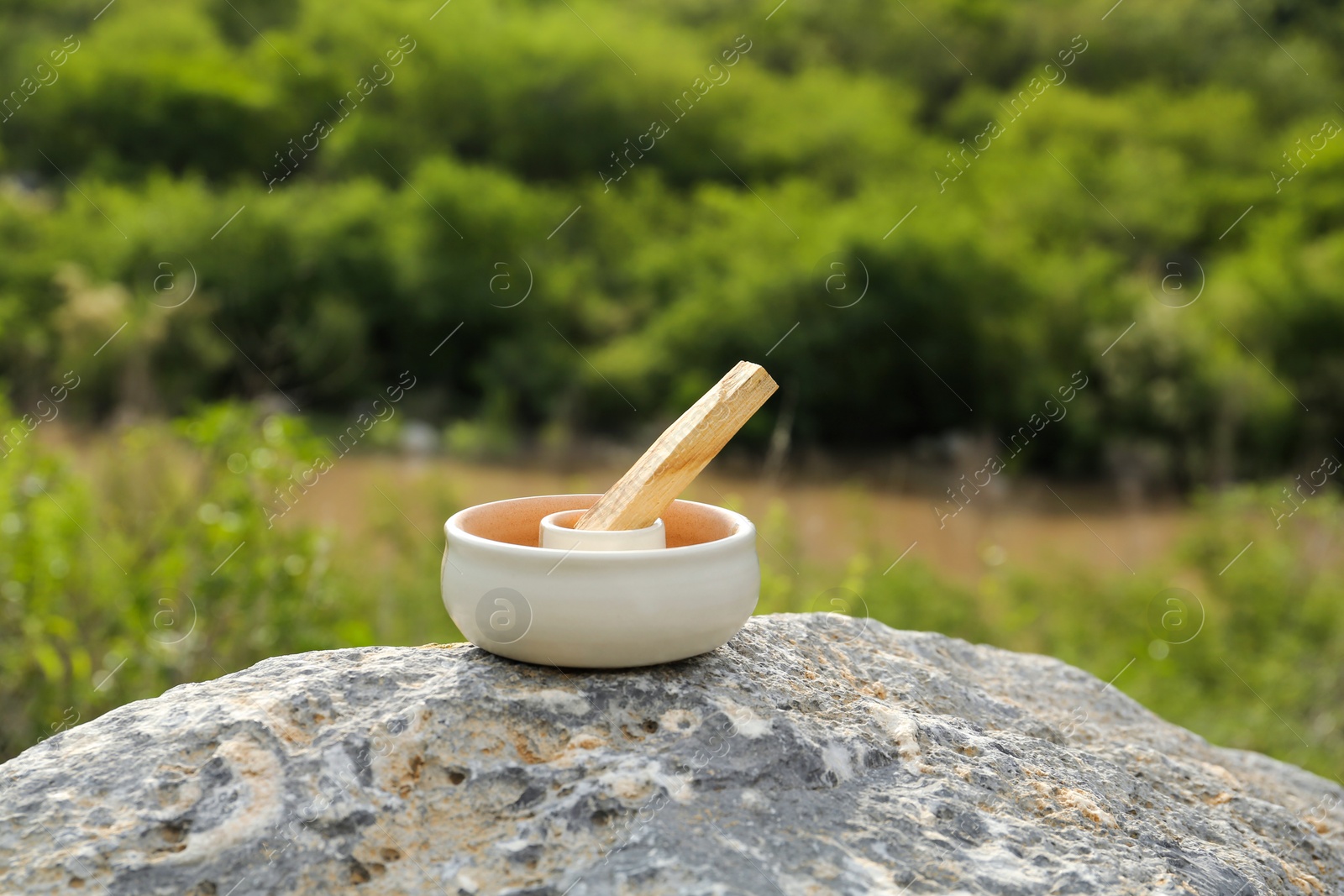 Photo of Palo santo stick on stone surface outdoors