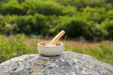 Photo of Palo santo stick on stone surface outdoors