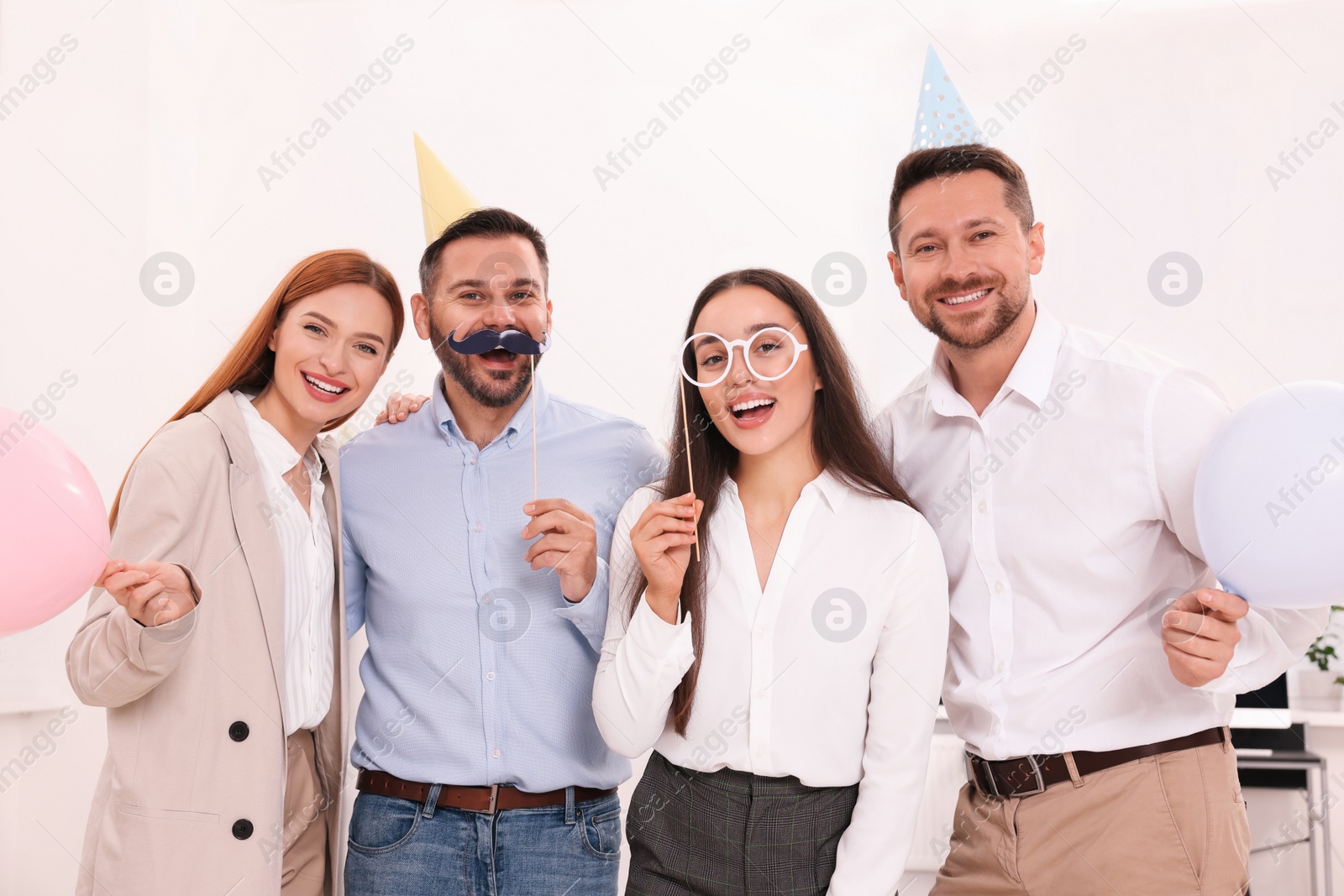 Photo of Coworkers having fun during office party indoors