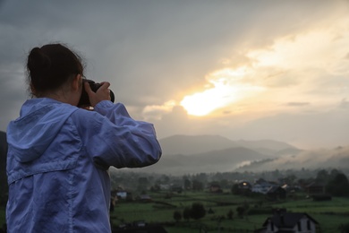 Photo of Professional nature photographer taking photos in mountains