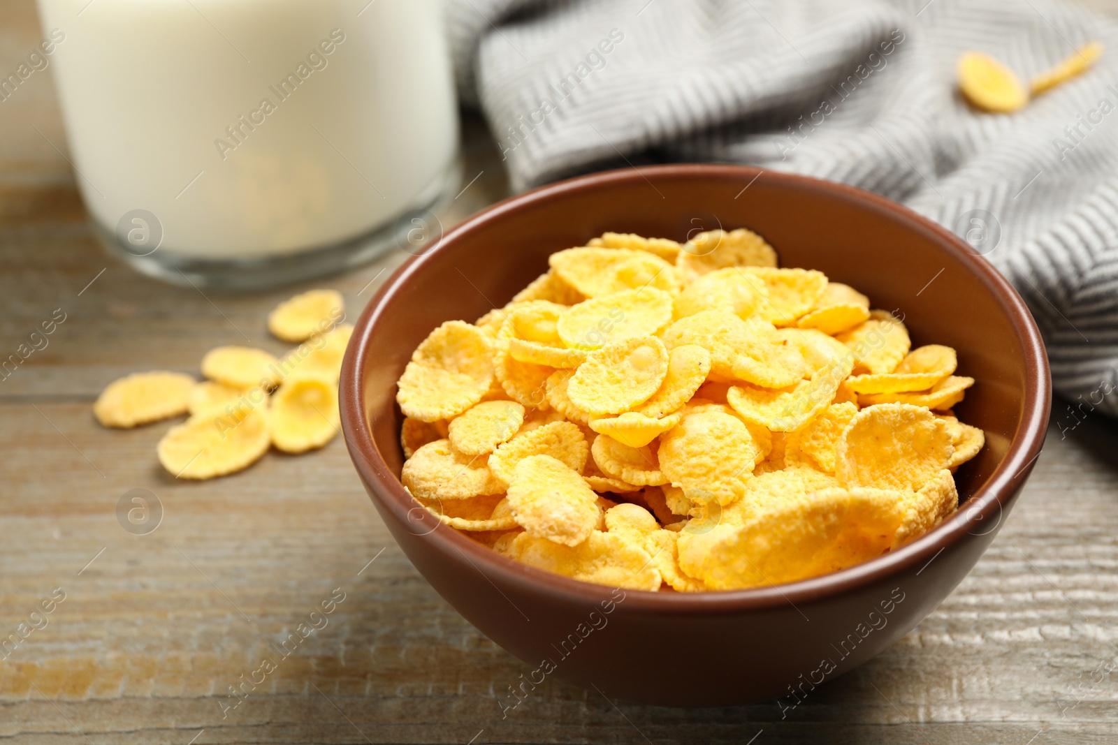 Photo of Tasty crispy corn flakes on wooden table