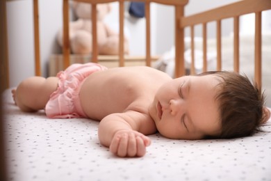 Cute little baby sleeping in crib at home. Bedtime