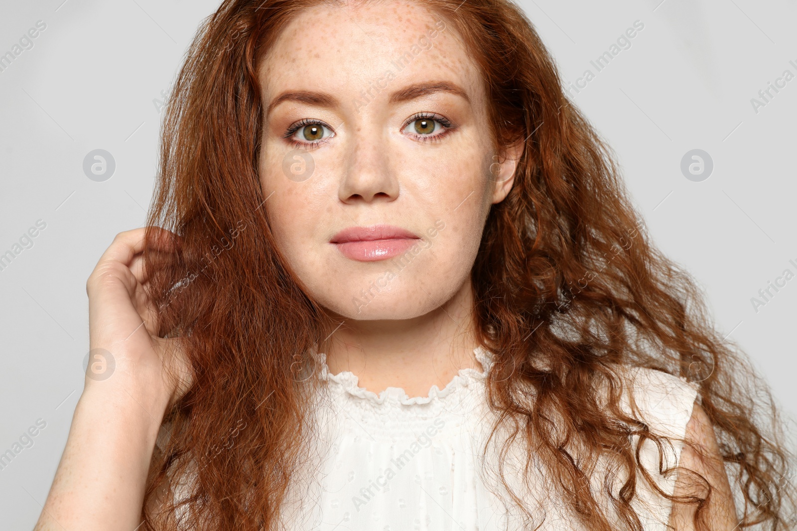 Photo of Portrait of young woman with beautiful face on grey background, closeup