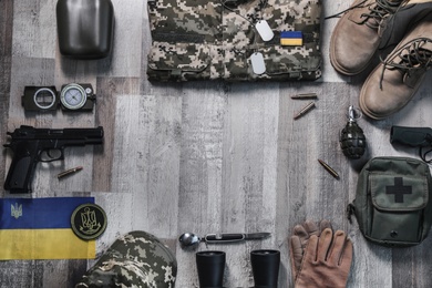 Photo of MYKOLAIV, UKRAINE - SEPTEMBER 19, 2020: Ukraine military outfit and equipment on floor, flat lay. Space for text