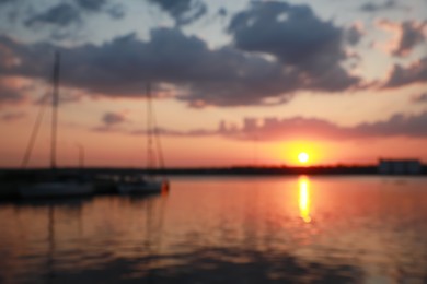 Photo of Blurred view of river pier at sunset