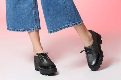 Photo of Woman in stylish shoes on color background, closeup