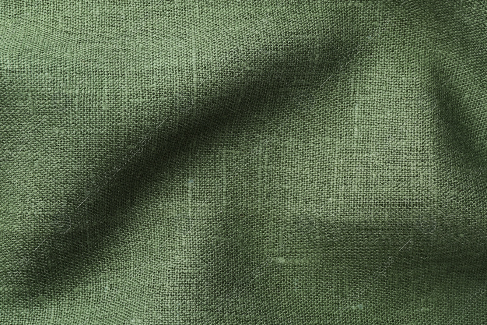 Photo of Texture of green crumpled fabric as background, top view