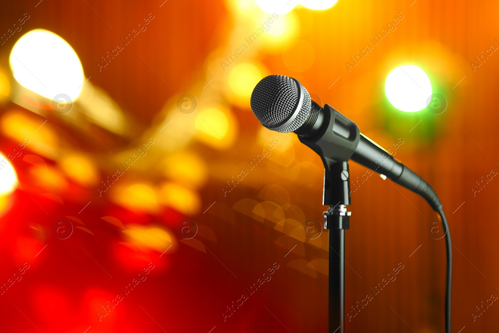 Photo of Microphone against festive lights, space for text