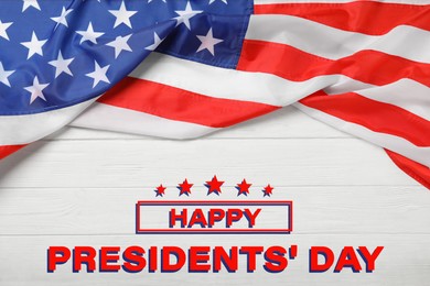 Happy President's Day - federal holiday. American flag and text on white woooden background, top view