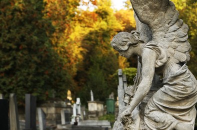 Photo of Beautiful statueangel at cemetery, space for text. Funeral ceremony