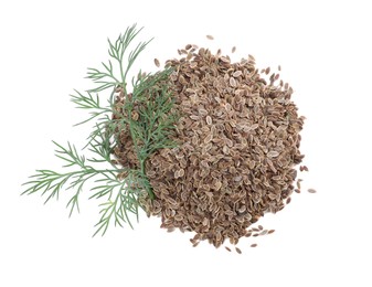 Photo of Heap of dry seeds and fresh dill isolated on white, top view