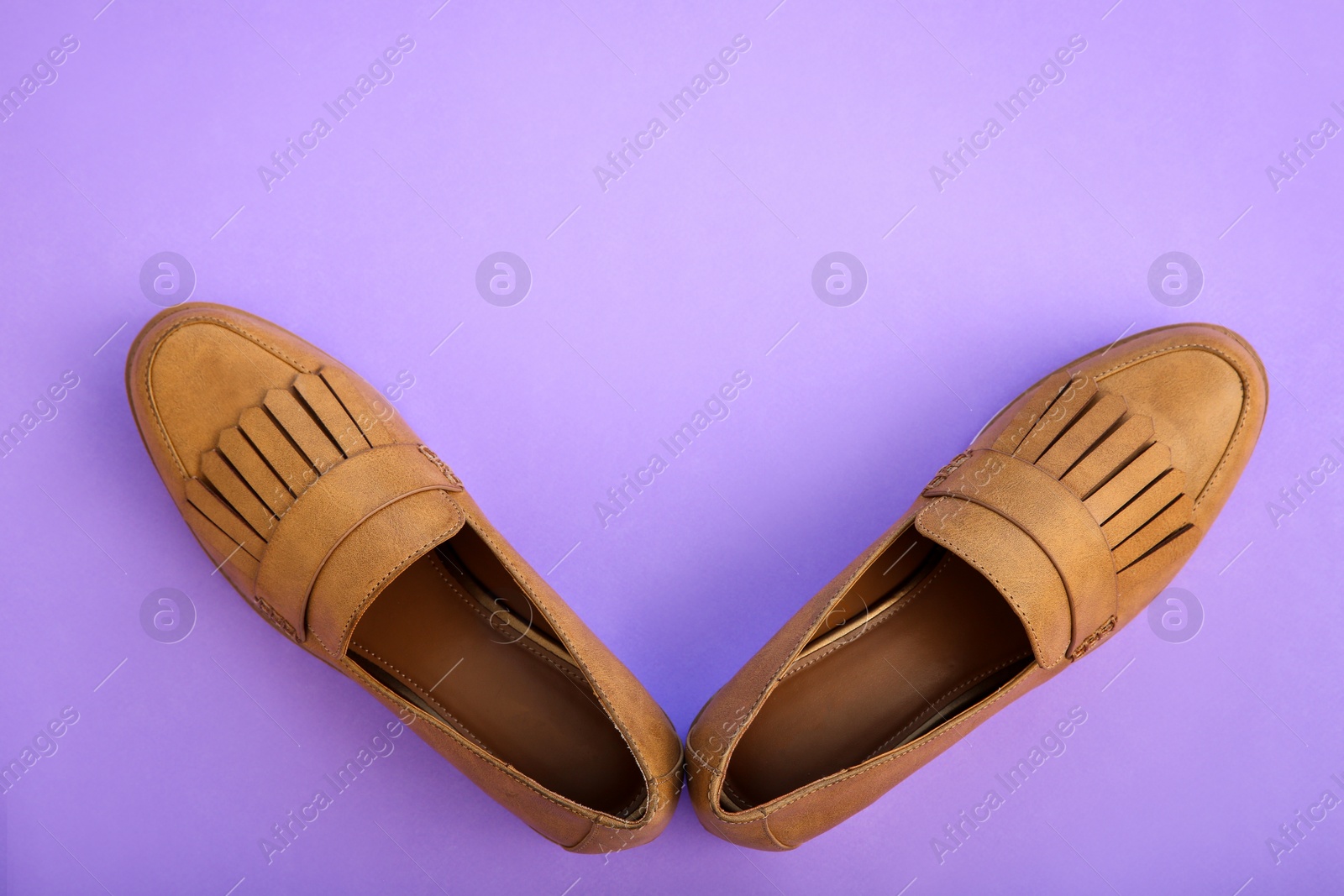 Photo of Pair of female shoes on color background