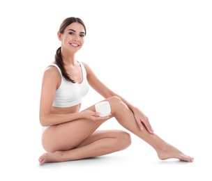 Young woman with jar of cream on white background. Beauty and body care