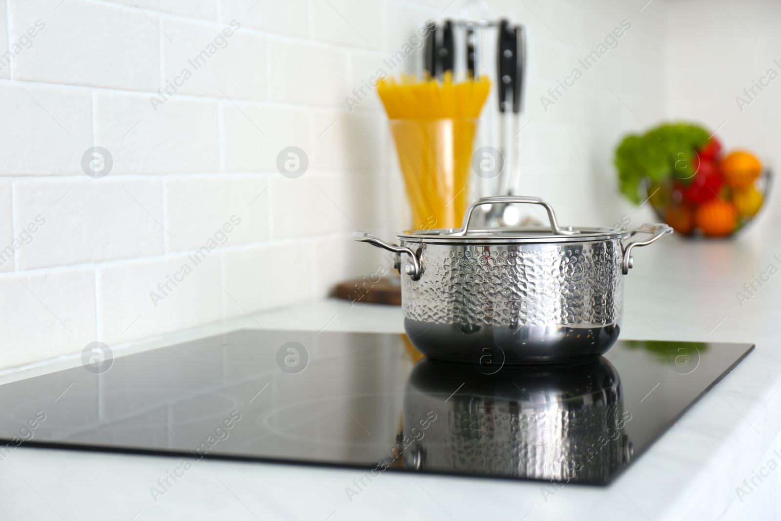 Photo of New saucepot on induction stove in kitchen