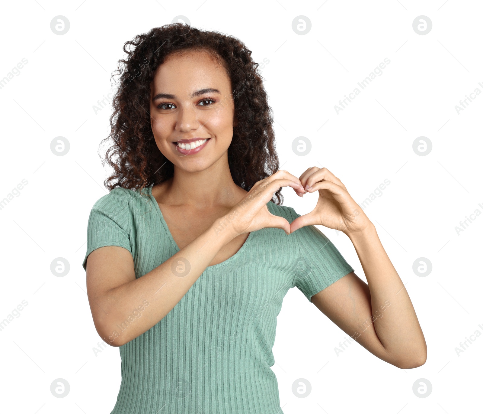 Photo of Happy young African-American woman making heart with hands on white background