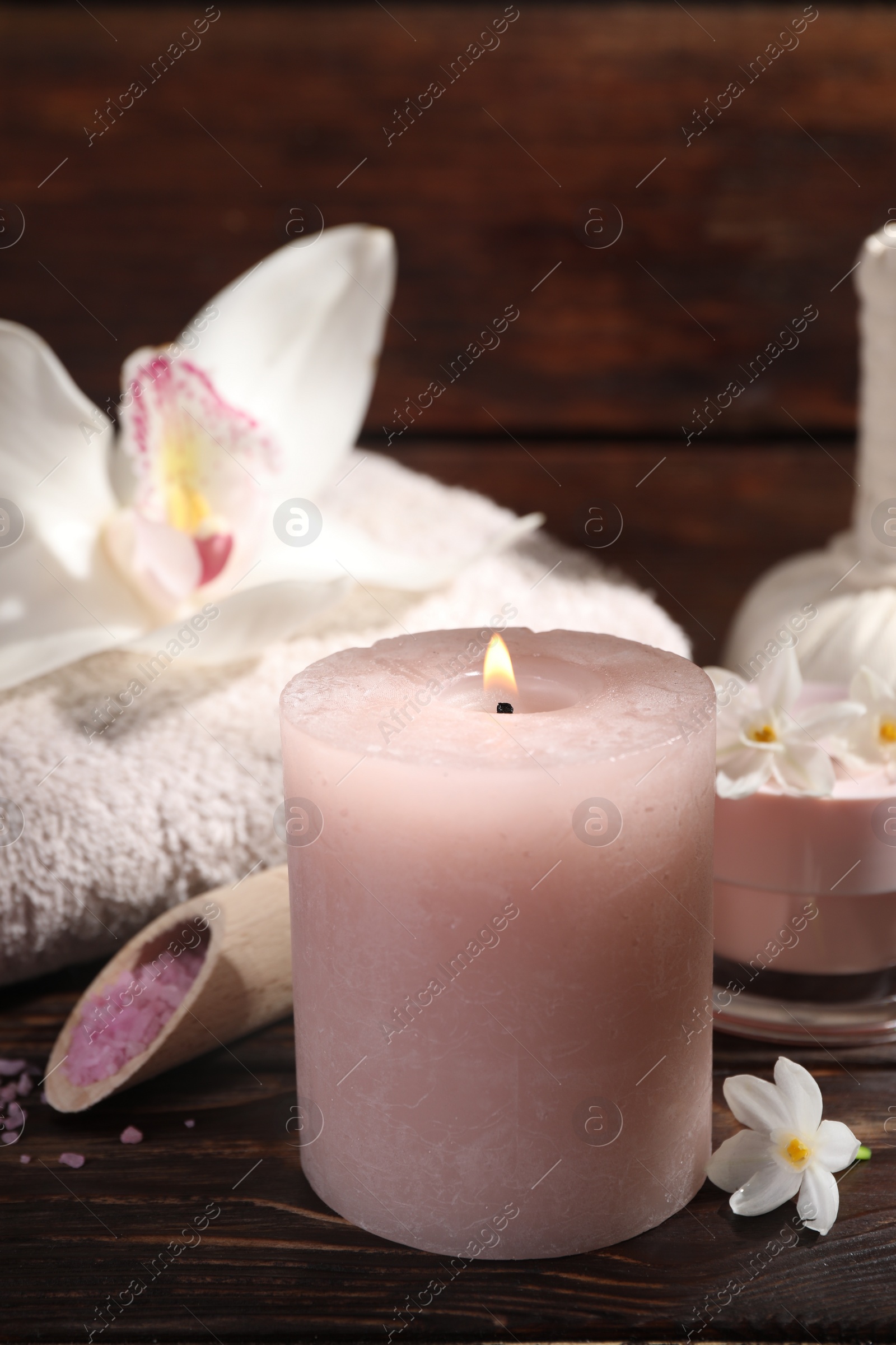 Photo of Composition with spa supplies and flowers on wooden table