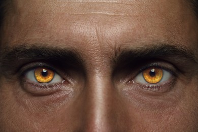 Evil eye, captivating gaze. Man with rare eye color, closeup