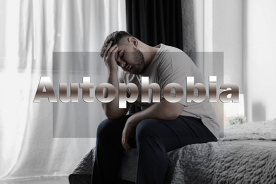 Image of Depressed overweight man sitting alone on bed at home. Autophobia - fear of isolation