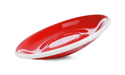 Photo of One red ceramic saucer isolated on white