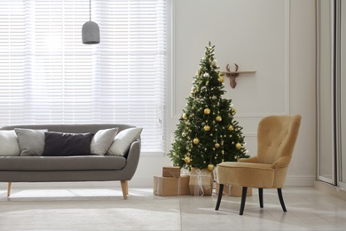 Beautiful Christmas tree and sofa in contemporary living room. Interior design