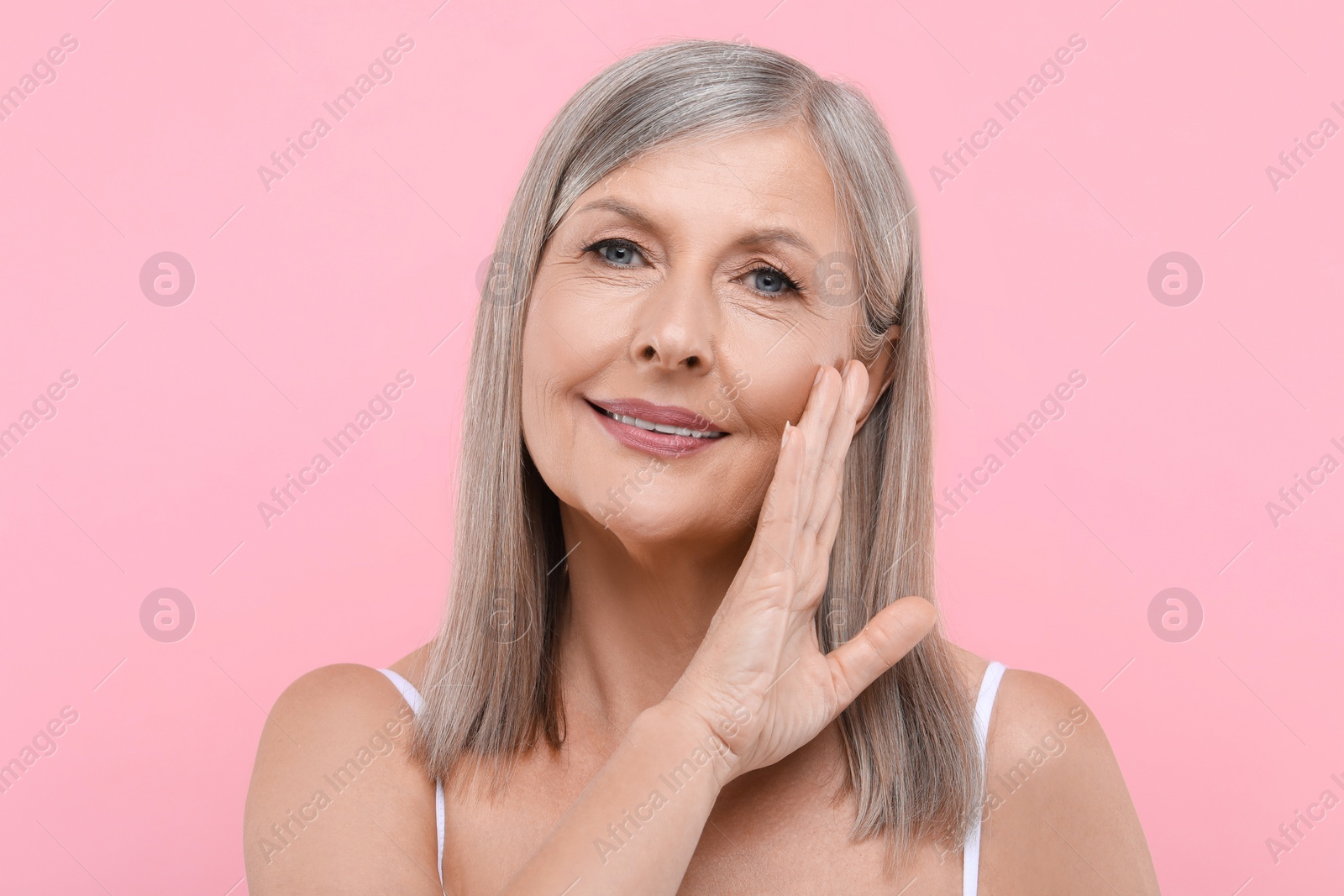 Photo of Portrait of beautiful senior woman on pink background