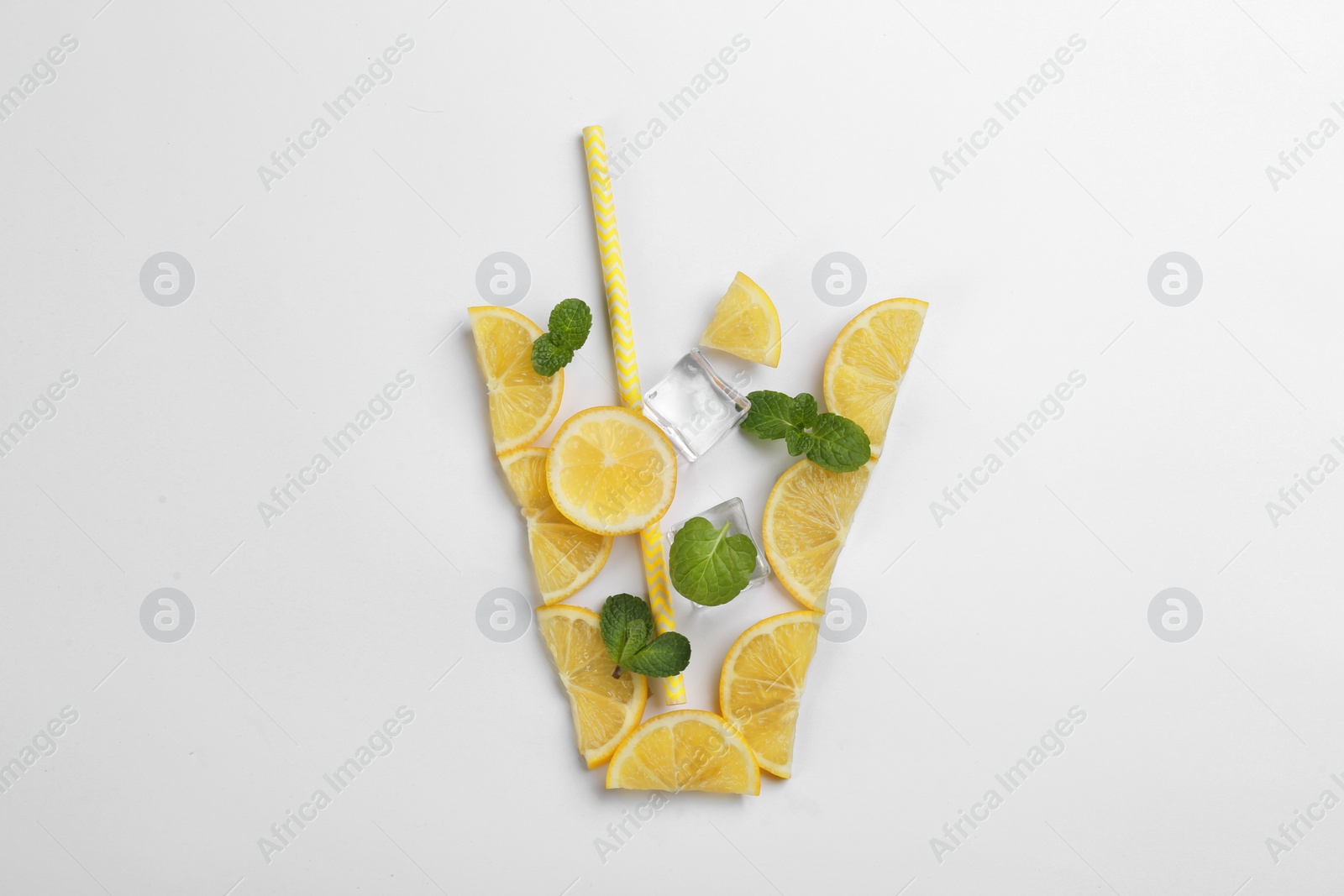 Photo of Creative lemonade layout with lemon slices, straw, ice cubes and mint on white background, top view