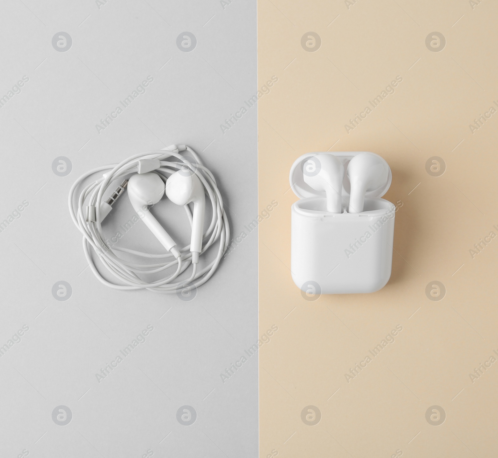 Photo of Flat lay composition with different earphones on color background