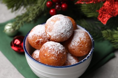 Delicious sweet buns in bowl and decor on table, closeup