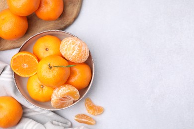 Photo of Fresh juicy tangerines on light grey table, flat lay. Space for text