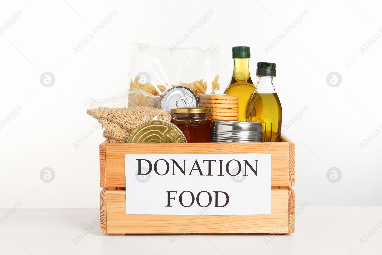 Photo of Donation crate with food isolated on white