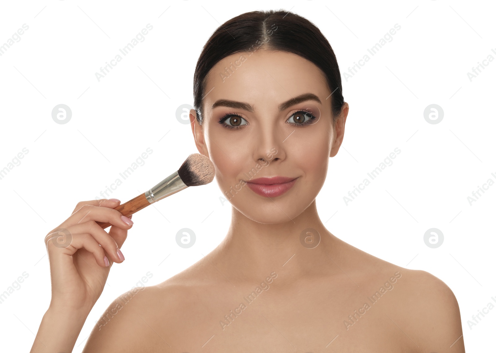 Photo of Beautiful young woman applying face powder with brush on white background