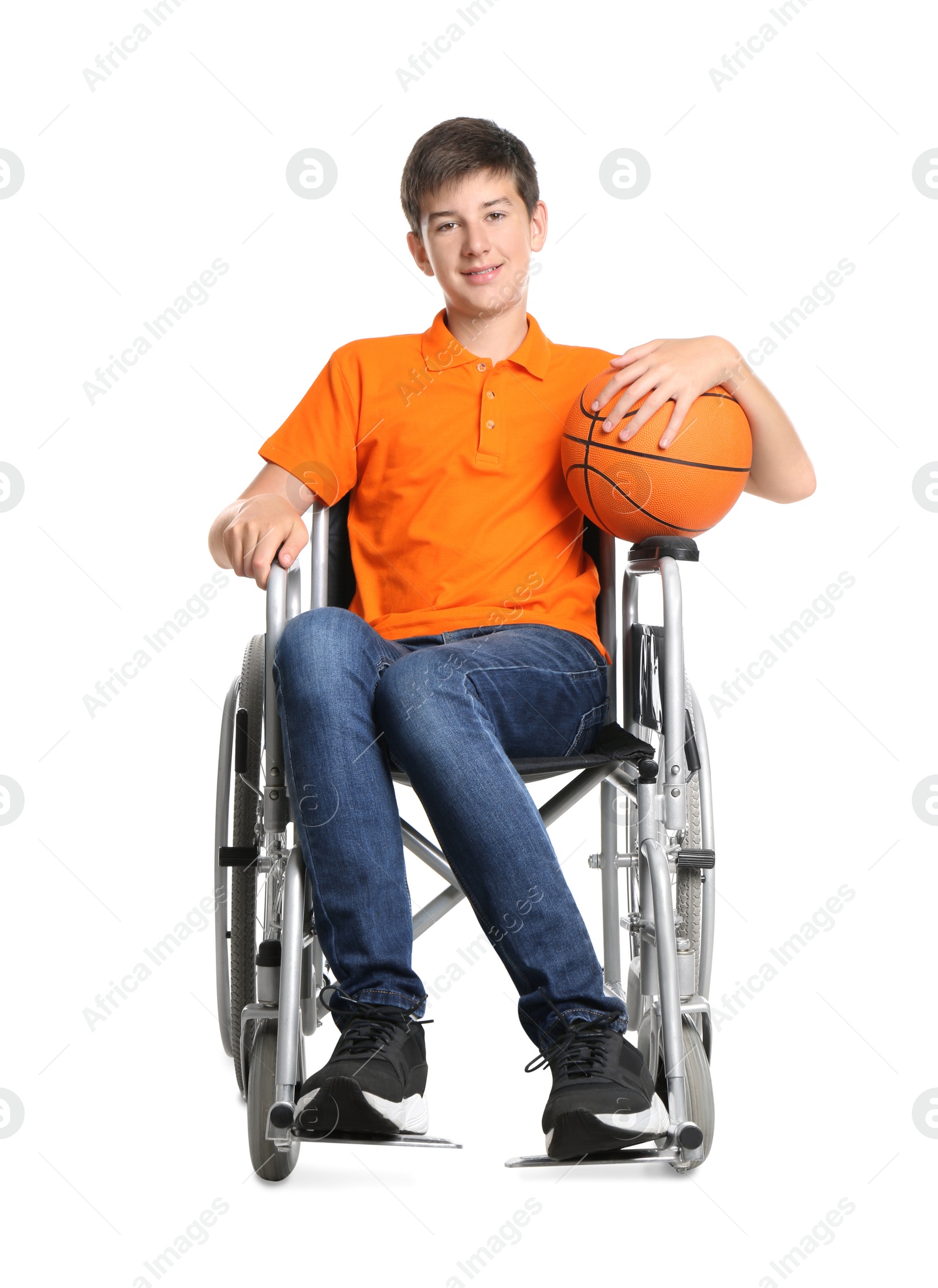 Photo of Disabled teenage boy in wheelchair with basketball ball on white background