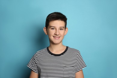 Photo of Happy teenage boy on light blue background