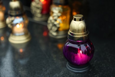 Photo of Grave lights on granite surface at cemetery